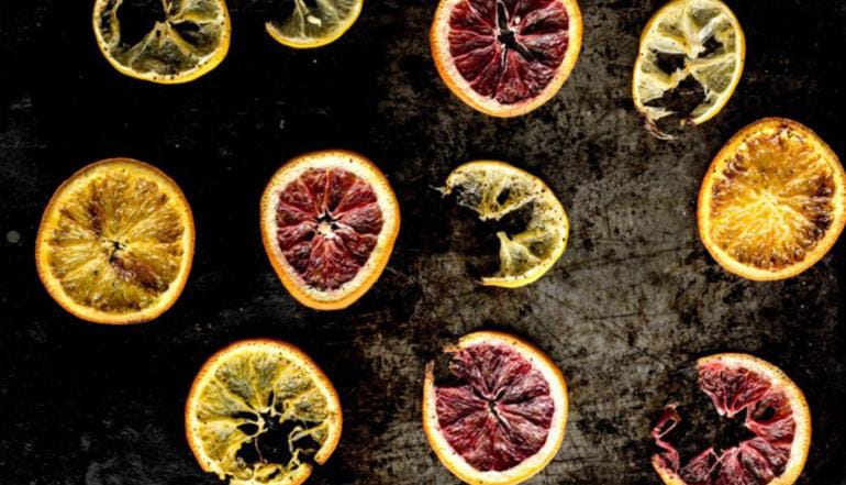 Fresh citrus fruits and green herbs representing top notes of perfume